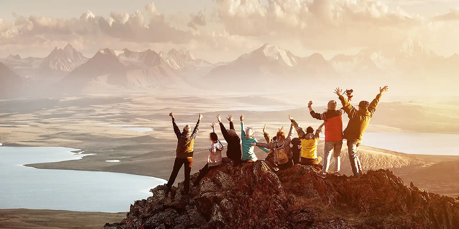 A group of people standing on top of a mountain.